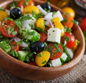 photo of Greek salad with feta cheese and black olives